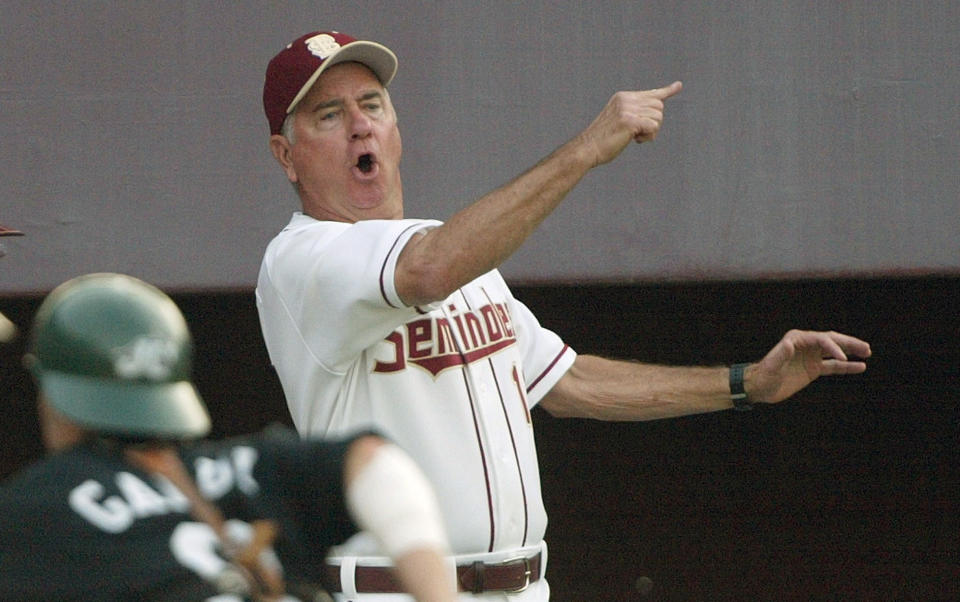 FILE - Florida State coach Mike Martin yells for runner Matt Sauls to head for second as the ball gets by Jacksonville catcher Jon Galui, left, during the third inning in the NCAA regional game Friday, May 30, 2003, in Tallahassee, Fla. Mike Martin, a member of the College Baseball Hall of Fame who won an NCAA Division I record 2,029 games in 40 seasons as Florida State’s baseball coach, died Thursday, Feb. 1, 2024, after a three-year battle with dementia. He was 79. (AP Photo/Phil Coale, File)