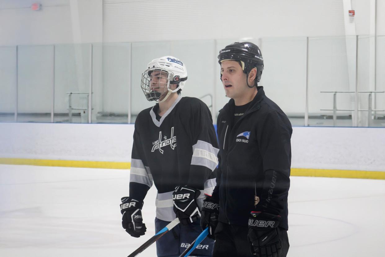 Olentangy Liberty interim coach Jonathon Falvo talks with Elias Ponte during practice Tuesday at Chiller North. Liberty plays St. Charles in the regional final Saturday at OhioHealth Ice Haus.