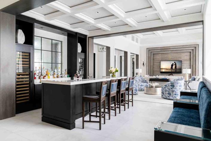 Created for ultimate entertainment, the custom home features an open great room that flows into a bar, kitchen and dining area that can easily host 30 comfortably and effortlessly.