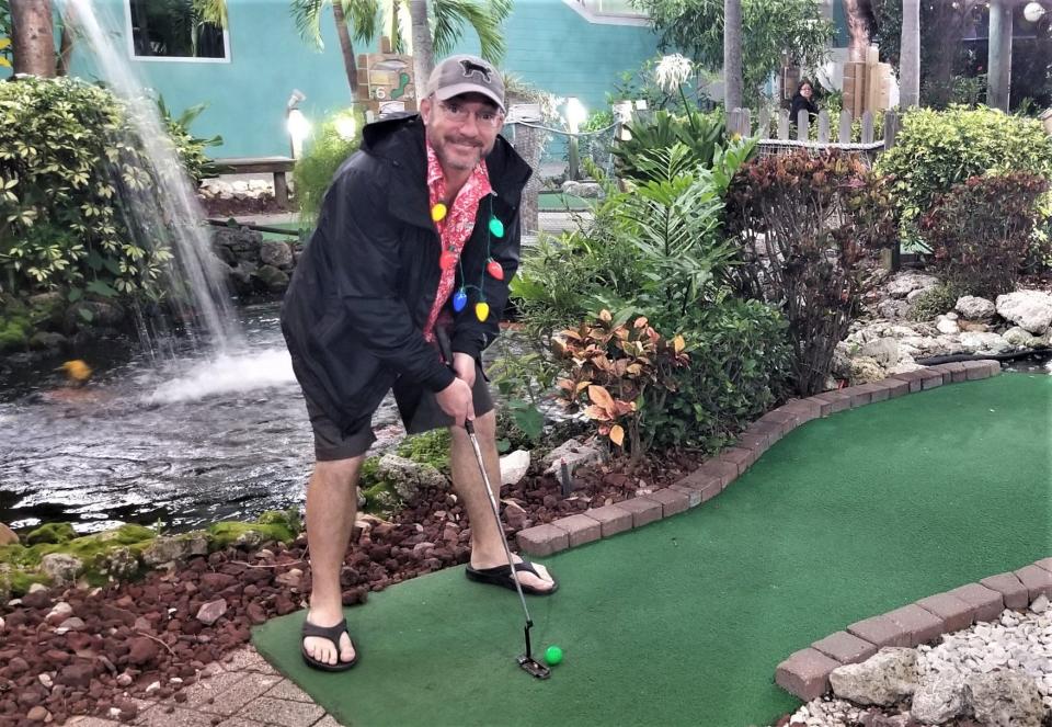 Wade Tatangelo prepares to putt on the 18th hole at Fish Hole Miniature Golf on Bridge Street in Bradenton Beach on Anna Maria Island, Dec. 17, 2022, during Christmas on Bridge Street.