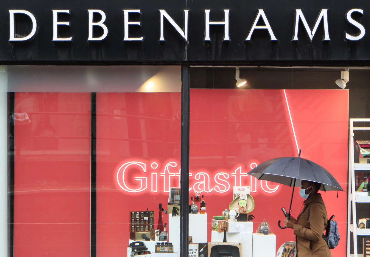 A woman walks past a Debenhams store in Manchester in the final week of a four week national lockdown to curb the spread of coronavirus. (Photo by Danny Lawson/PA Images via Getty Images)