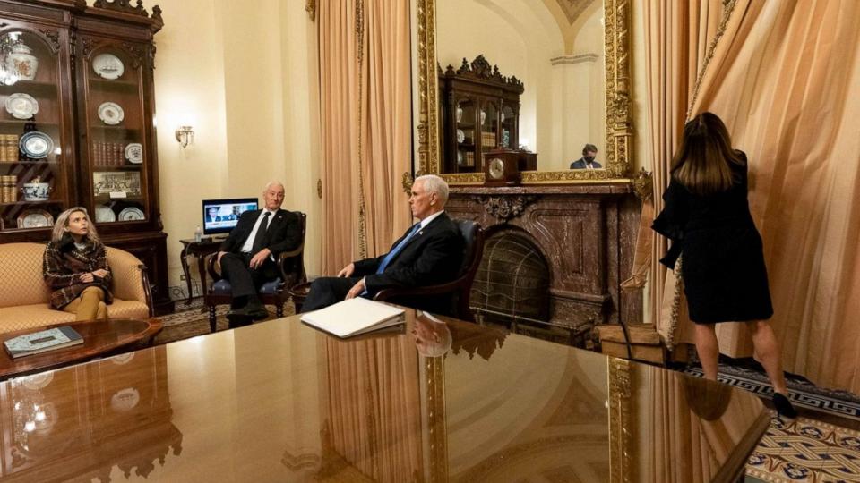 PHOTO:  Vice President Mike Pence sits with his daughter and brother while wife Karen draws the curtains in ceremonial room off Senate floor where he was evacuated to as Trump supporters attacked U.S. Capitol, Jan. 6, 2021, (The White House)