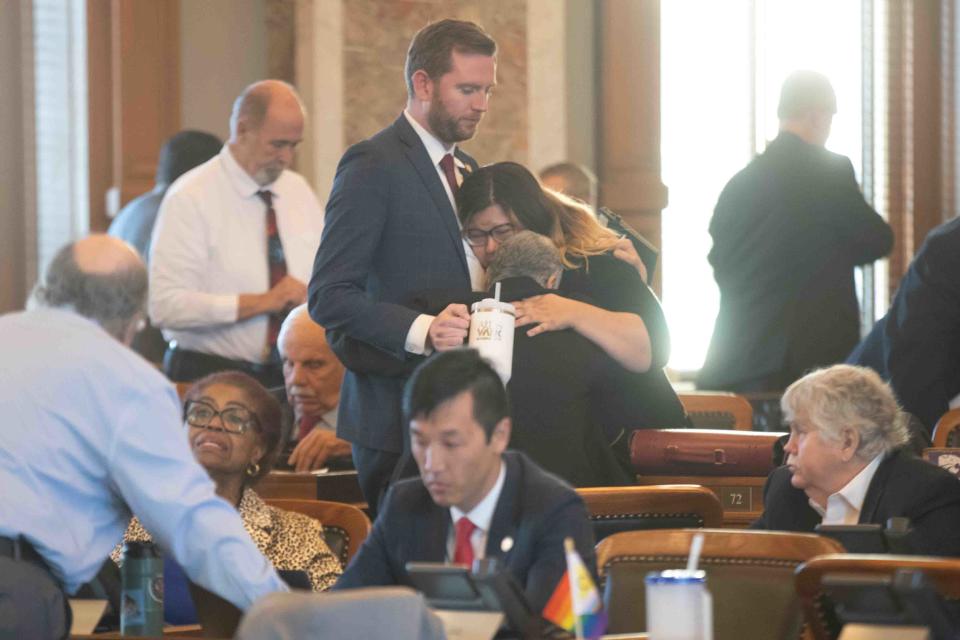 Rep. Heather Myer, D-Overland Park, Rep. Susan Ruiz, D-Shawnee, and Rep. Brandon Woodard, D-Lenexa, hug after the House voted to sustain Gov. Laura Kelly's veto of Senate Bill 233 on Monday.