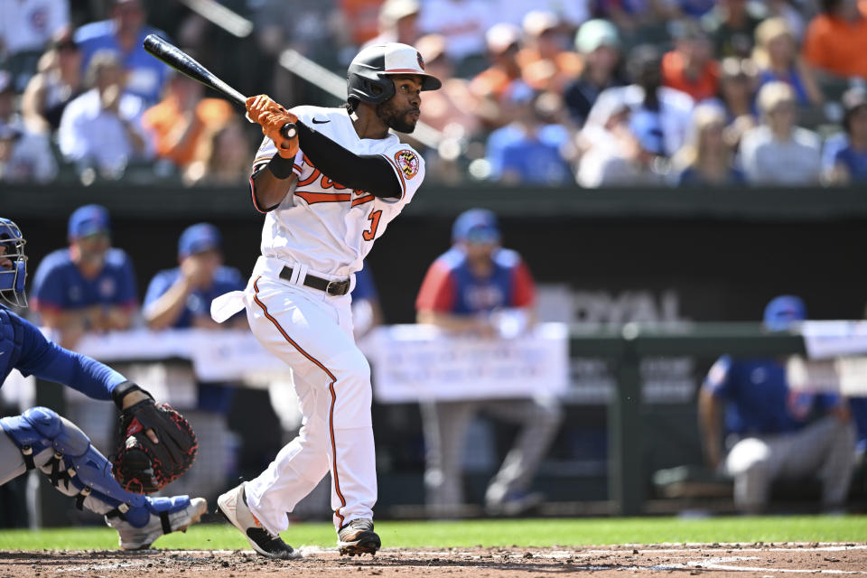 Baltimore Orioles' Cedric Mullins follows through on a triple against the Chicago Cubs in the third inning of a baseball game, Thursday, Aug. 18, 2022, in Baltimore. (AP Photo/Gail Burton)