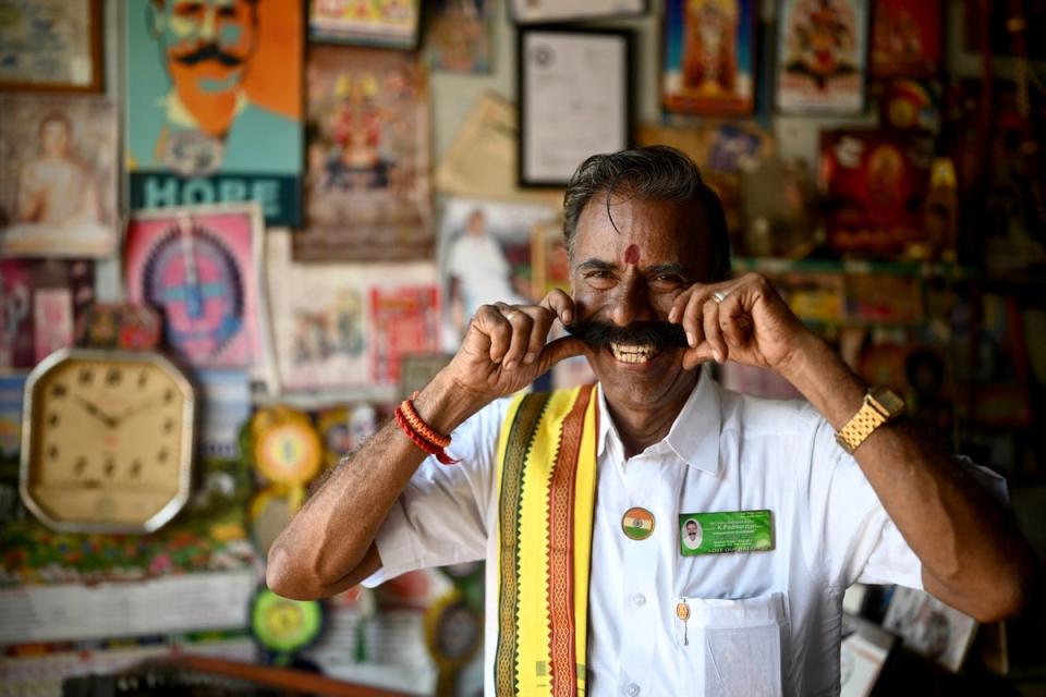 K Padmarajan twirls his moustache while posing for a photograph at his office in Mettur, near Salem district in India’s Tamil Nadu state (AFP via Getty Images)