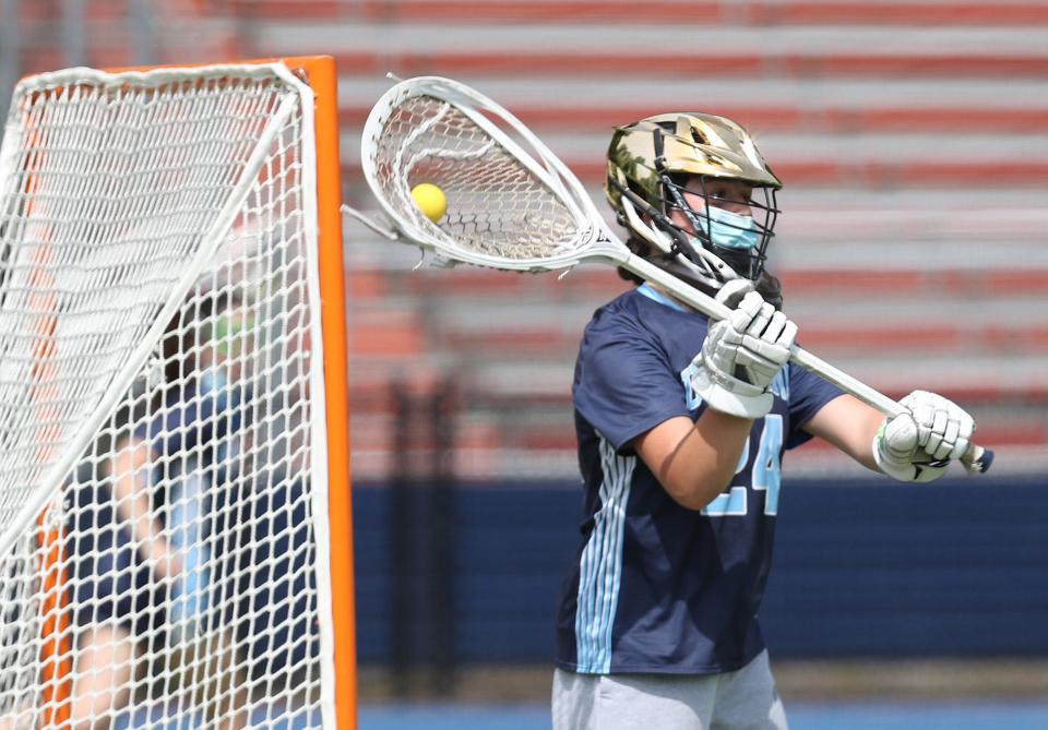 Ursuline goalie Lucy Gomez looks to pass after making a save during a May 22, 2021 girls lacrosse game against Horace Greeley.