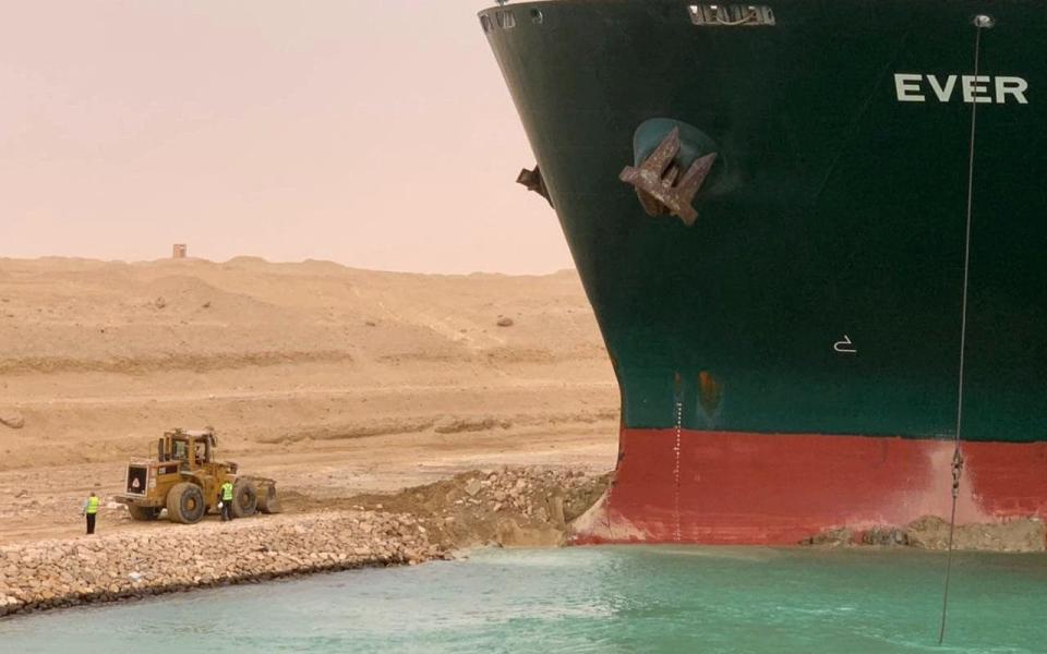 Part of the vessel, lodged sideways into the bank of the canal - MARINA PASSOS/Suez CANAL/AFP via Getty Images