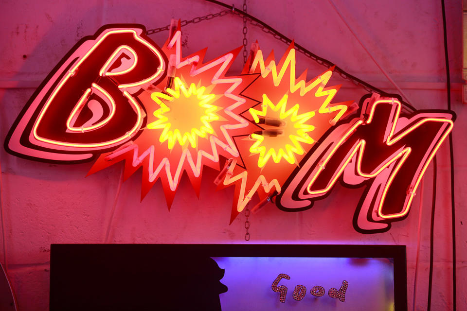 A neon sign that reads ‘BOOM’