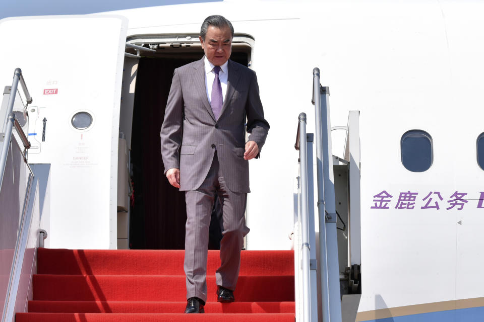 In this photo released by Agence Kampuchea Press (AKP), Chinese Foreign Minister Wang Yi arrives at Phnom Penh International Airport in Phnom Penh, Cambodia, Sunday, April 21, 2024. (AKP via AP)