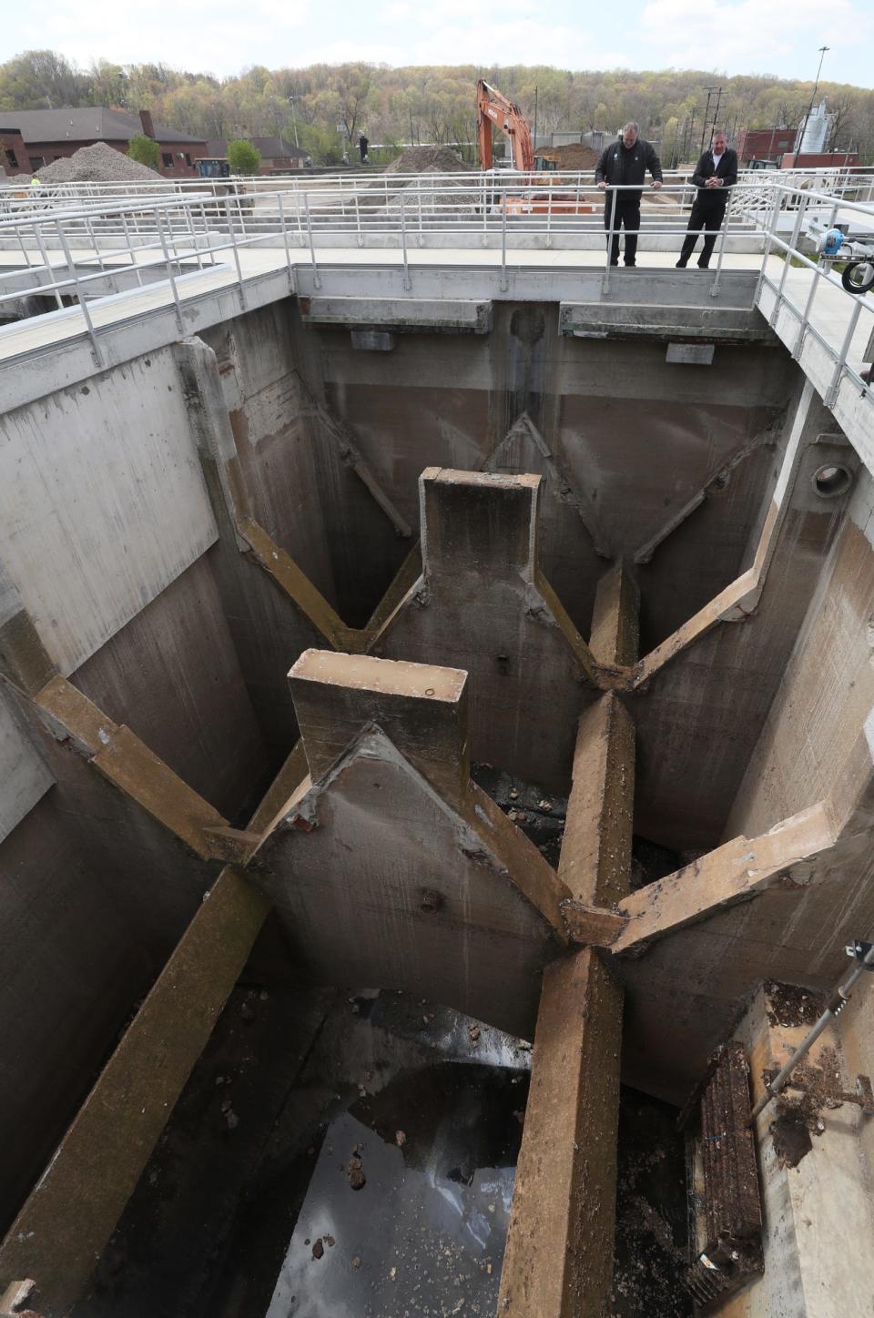 Steve Baytos IV, Akron Water Reclamation Facility superintendent, and Chris Ludle, Akron's director of public service, look at the original retention tanks from 1930, which are now used as quarantine tanks at the Akron Water Reclamation Facility.