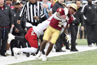 Louisville defensive back Jarvis Brownlee tackles Boston College running back Zay Flowers during the fourth quarter of an NCAA college football game Saturday, Oct. 1, 2022, in Boston. (AP Photo/Mark Stockwell)