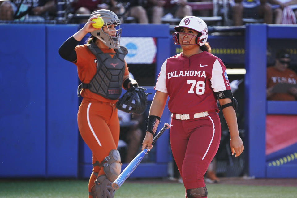 Oklahoma's Jocelyn Alo (78) walks back to the dugout after striking out during the first inning of the second game of the team's NCAA softball Women's College World Series finals against Texas on Thursday, June 9, 2022, in Oklahoma City. (AP Photo/Sue Ogrocki)