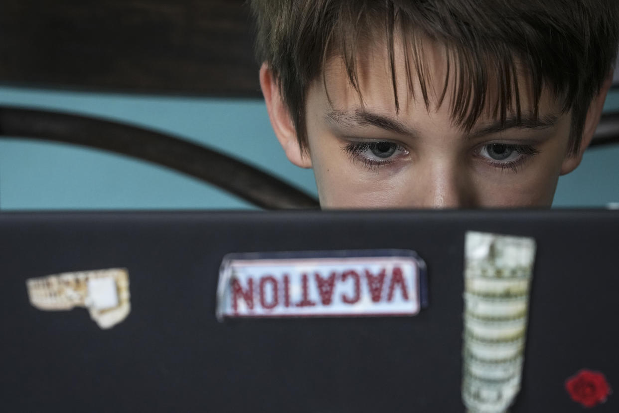 Kim Hough's 12-year-old son Ethan browses book selections on the Epic app. (Jacob M. Langston for NBC News)