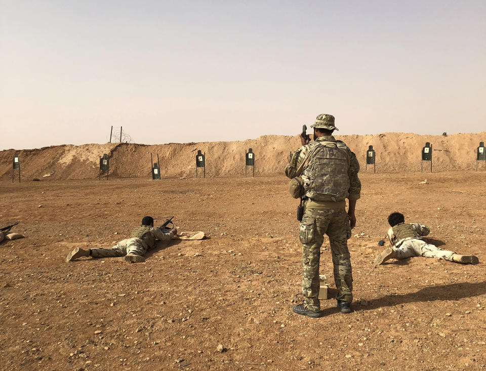 Members of the Maghawir al-Thawra Syrian opposition group receive firearms training from U.S. Army Special Forces soldiers at the al-Tanf military outpost in southern Syria on Monday, Oct. 22, 2018. (AP Photo/Lolita Baldor)