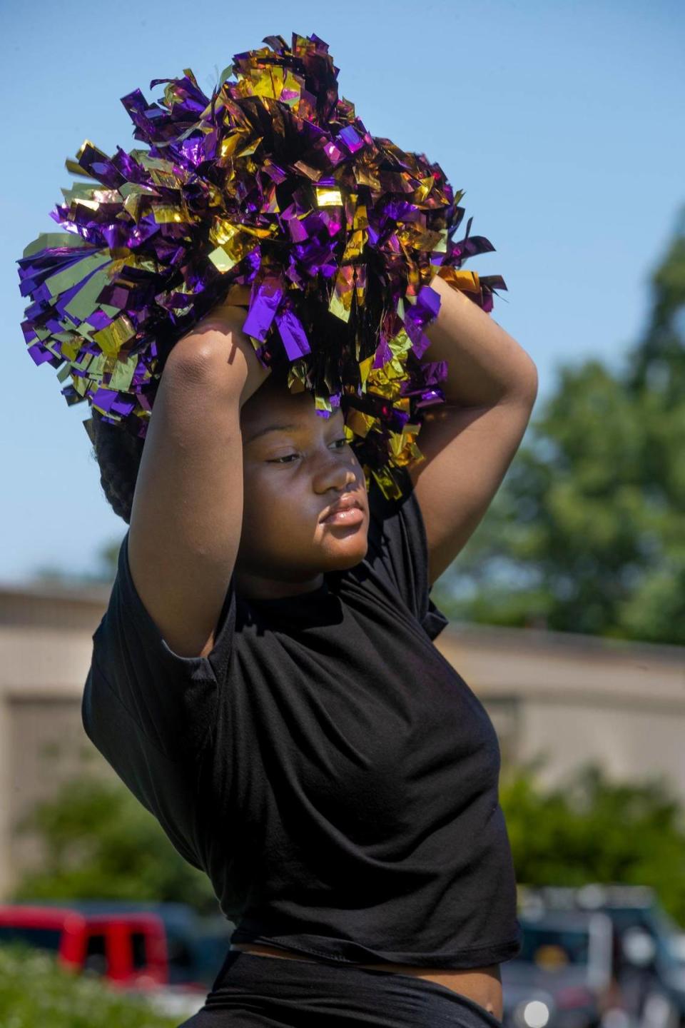 Amani Tinnin, 11, a member of the Reign KC Dance Corp used her pompoms for some shade before the Juneteenth KC 2021 Cultural Parade Saturday, June 12, 2021 in the Historic Jazz District near 18th and Vine.