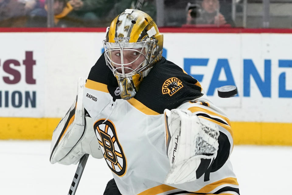 Boston Bruins goaltender Jeremy Swayman (1) deflects a Detroit Red Wings shot in the first period of an NHL hockey game Sunday, March 12, 2023, in Detroit. (AP Photo/Paul Sancya)