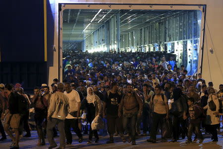 Refugees and migrants disembark from the passenger ship "Tera Jet", following their trip from the island of Lesbos to the port of Piraeus, near Athens, Greece September 1, 2015. REUTERS/Alkis Konstantinidis