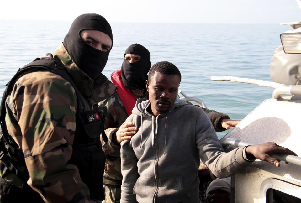 A migrant from sub-Saharan Africa is stopped by Tunisian Maritime National Guard at sea during an attempt to get to Italy, near the coast of Sfax, Tunisia, Tuesday, April 18, 2023. The Associated Press, on a recent overnight expedition with the National Guard, witnessed migrants pleading to continue their journeys to Italy in unseaworthy vessels, some taking on water. Over 14 hours, 372 people were plucked from their fragile boats. (AP Photo)