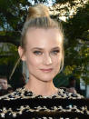 BEST BUN: Diane Kruger: We love Kruger's top knot and loose strands. Frankly, this woman can do no wrong. To create a similar look, flip hair upside down and tie into a high ponytail at the crown of your head. Flip upright and wrap hair into a bun around the elastic. Use a pair of spin pins for extra hold before pinning the style into place with bobby pins. photo credit: George Pimentel