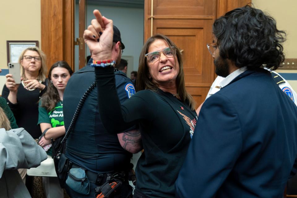 Patricia Oliver the mother of Joaquin Oliver, one of the victims of the 2018 mass shooting at Marjory Stoneman Douglas High School in Parkland, Fla., is removed from the hearing room on Capitol Hill in Washington, Thursday, March 23, 2023. (AP Photo/Manuel Balce Ceneta) ORG XMIT: DCMC122