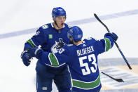 Vancouver Canucks' Nikita Zadorov celebrates his goal against the Edmonton Oilers with Teddy Blueger during the third period of Game 1 of a second-round NHL hockey Stanley Cup playoffs series, Wednesday, May 8, 2024, in Vancouver, British Columbia. (Ethan Cairns/The Canadian Press via AP)