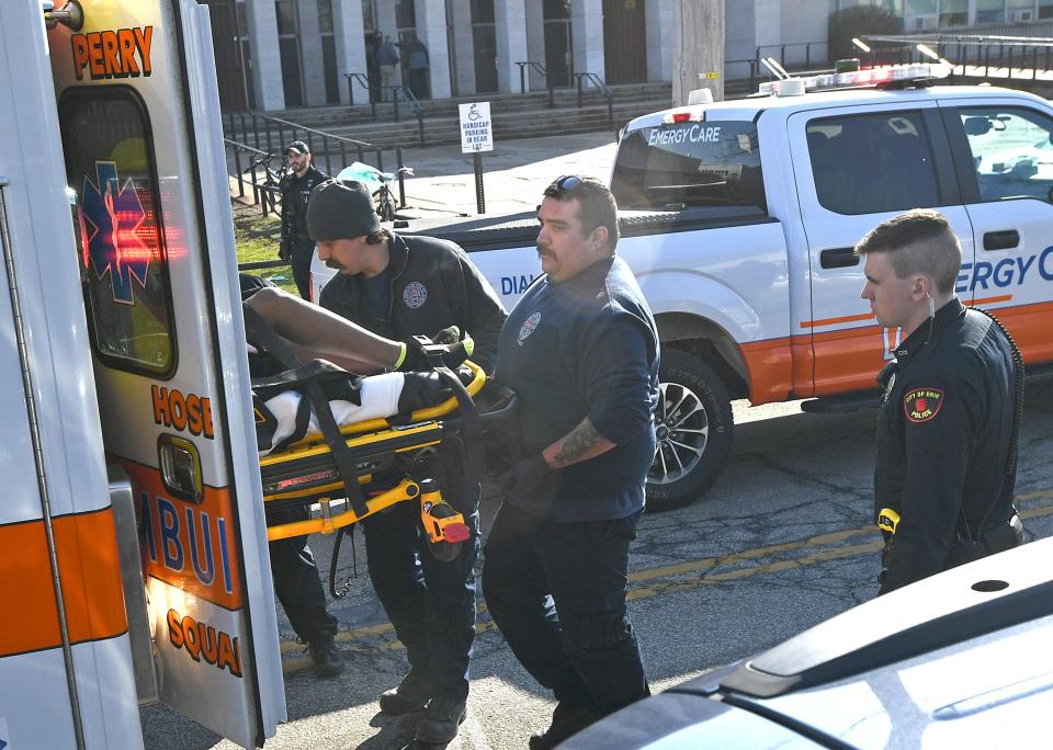 A male shooting victim is loaded into an ambulance in front of Erie High School, on Thursday, following a shooting at the school. The victim was shot in the leg and suffered what police described as injuries that are not life-threatening.