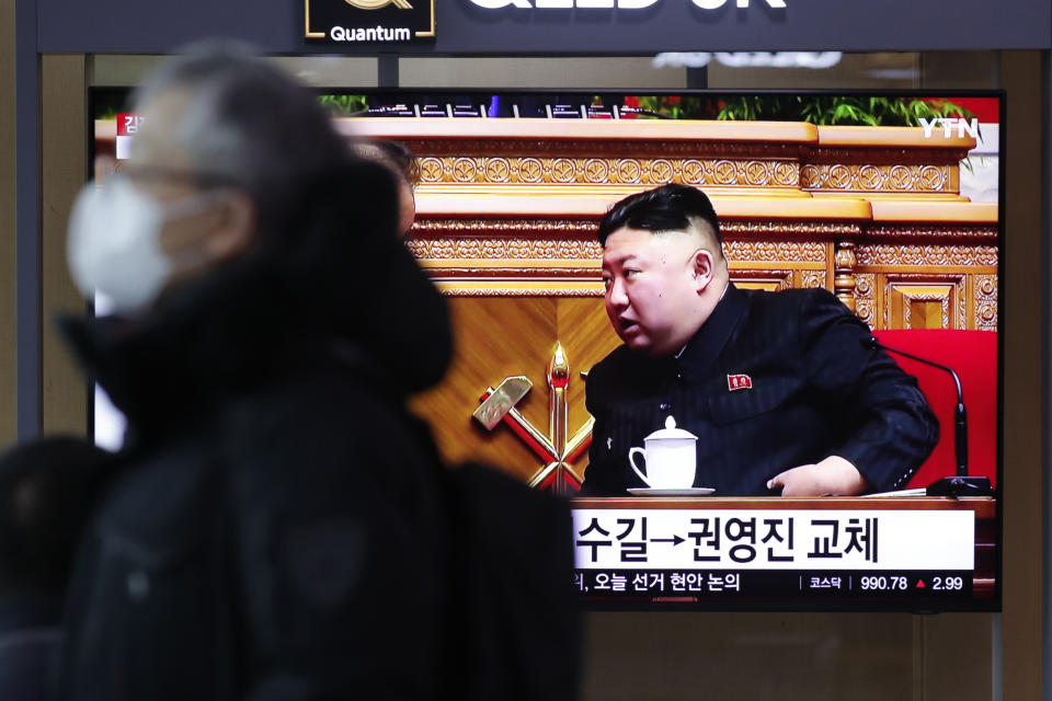 A man wearing a face mask walks past near a TV screen showing a footage of North Korean leader Kim Jong Un, at the Seoul Railway Station in Seoul, South Korea, Monday, Jan. 11, 2021. Kim was given a new title, “general secretary” of the ruling Workers’ Party, formerly held by his late father and grandfather, state media reported Monday, in what appears to a symbolic move aimed at bolstering his authority amid growing economic challenges. (AP Photo/Lee Jin-man)