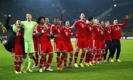 Bayern Munich's players celebrate victory against Borussia Dortmund during their German first division Bundesliga soccer match in Dortmund, November 23, 2013. REUTERS/Kai Pfaffenbach