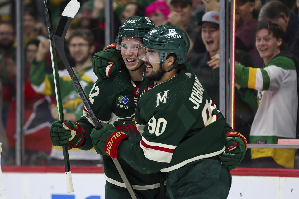 Minnesota Wild left wing Matt Boldy, left, celebrates his goal with left wing Marcus Johansson (90) during the third period of an NHL hockey game against the St. Louis Blues, Tuesday, Nov. 28, 2023, in St Paul, Minn. (AP Photo/Matt Krohn)