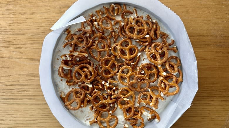 Pretzels over ice cream in cake pan