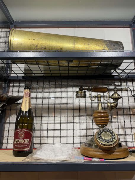 PHOTO: At Offensive, a new cafe in Kyiv, Ukraine, decorated with items representing the country's fight against the Russian invasion, including one of the last bottles of champagne produced in Bakhmut before Russians took control. (Yulia Drozd/ABC News)