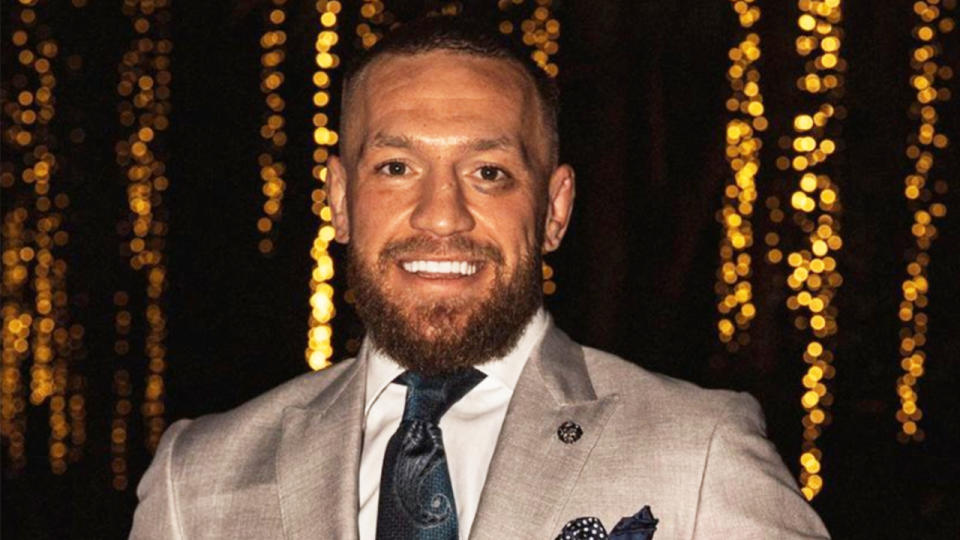 Conor McGregor (pictured) posing at a wedding.