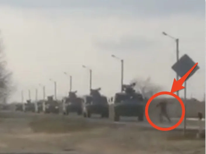 A video appears to show a Ukrainian man trying to block a Russian military convoy.