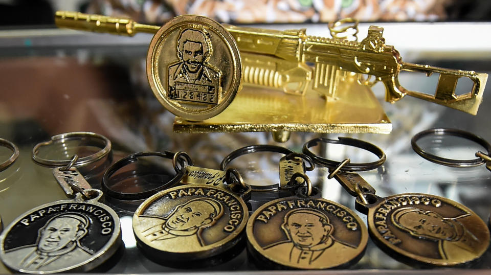 Souvenirs with the images of Pope Francis and late Colombian drug lord Pablo Escobar for sale at a store in the Pablo Escobar neighborhood in Medellin