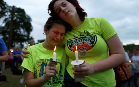 Mourners attend a vigil in memory of the victims killed in a shooting at Santa Fe High School - Credit: JONATHAN BACHMAN/Reuters