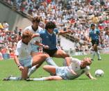 Diego Maradona (dark blue jersey) en route to scoring one of the greatest goals in football history, dribbling past England defenders in the 1986 World Cup quarter-finals. (PHOTO: Staff/AFP via Getty Images)