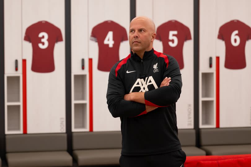 Arne Slot looks around the dressing room at Liverpool's AXA Training Centre