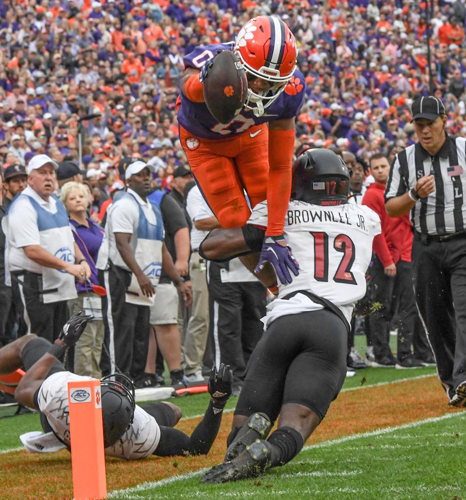 Clemson wide receiver Antonio Williams(0) leaps over Louisville defensive back Jarvis Brownlee Jr (12) toward the goal line during the first quarter at Memorial Stadium in Clemson, South Carolina Saturday, Nov. 12, 2022.  