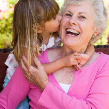 Grandmother getting a kiss from granddaughter web