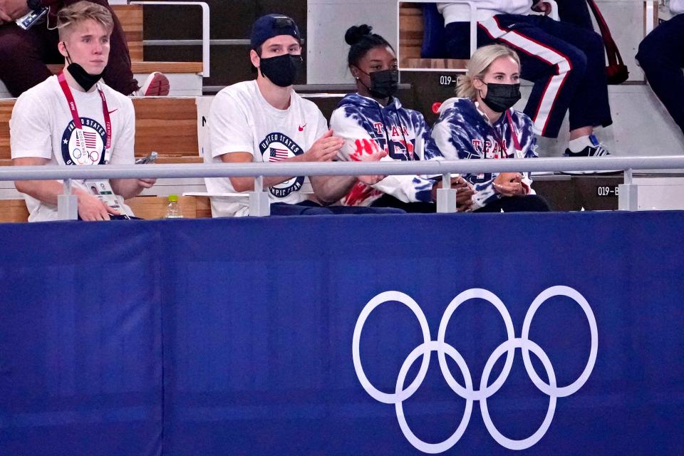 Simone Biles watches the men's individual all-around final.