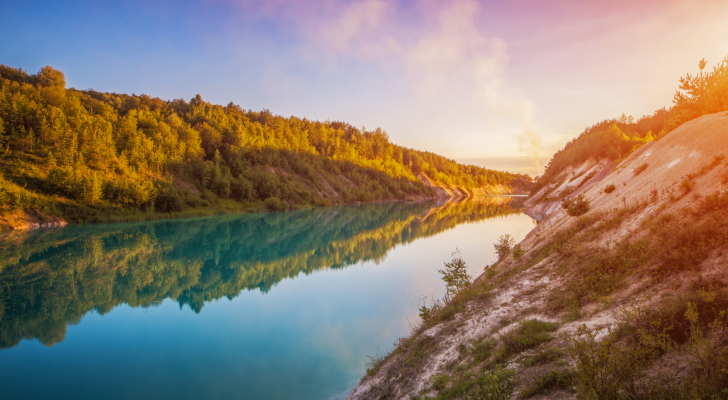 Flooded quarry for limestone mining. Turquoise water. White beaches. Water stocks.