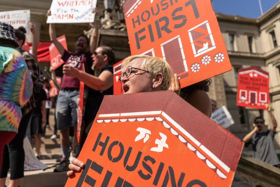 Kent County Progressive Caucus board member Amy Brock of Kentwood holds her sign while chanting with a speaker after talking about previously being homeless in Grand Rapids during a rally held by Rent Is Too Damn High coalition on the steps of the Michigan State Capitol building in Lansing on Tuesday, September 5, 2023, over renters rights and investment in affordable housing.