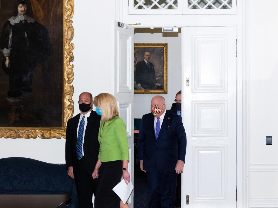 Governor Larry Hogan, wearing a mask decorated with Maryland’s state flag, and his staff participate in meetings and a press briefing at the State House in Annapolis on April 24. | Peter van Agtmael—Magnum Photos for TIME