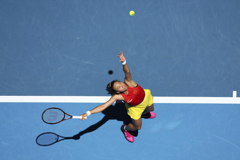 Qinwen Zheng of China serves to Marketa Vondrousova of the Czech Republic during the United Cup tennis tournament in Perth, Australia, Saturday, Dec. 30, 2023. (AP Photo/Trevor Collens)