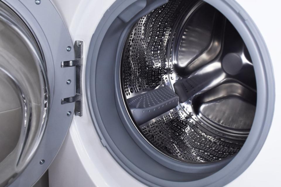 Front-loading washing machine with the door open to reveal a clean drum inside