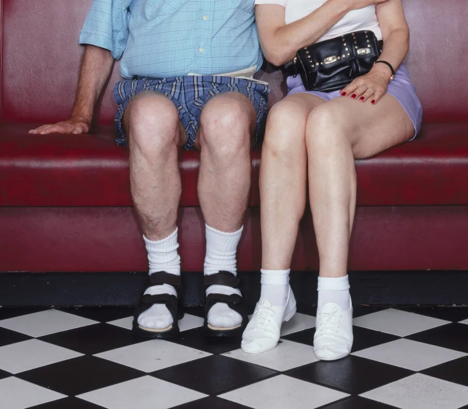 An older couple wearing high white socks.