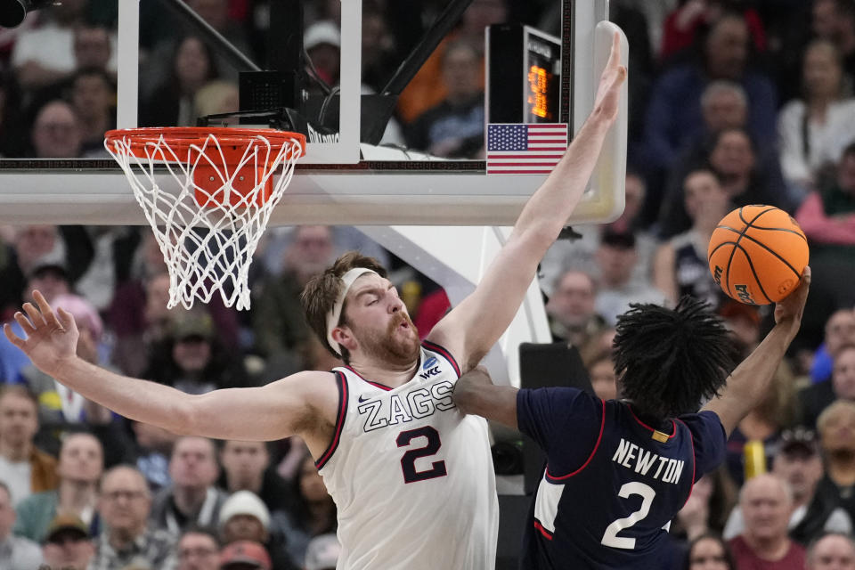 UConn guard Tristen Newton (2) shoots while defended by Gonzaga forward Drew Timme (2) in the first half of an Elite 8 college basketball game in the West Region final of the NCAA Tournament, Saturday, March 25, 2023, in Las Vegas. (AP Photo/John Locher)