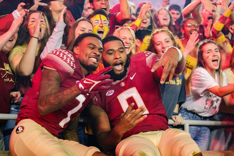 Florida State players celebrate with fans Saturday after defeating Miami 31-28 in Tallahassee.