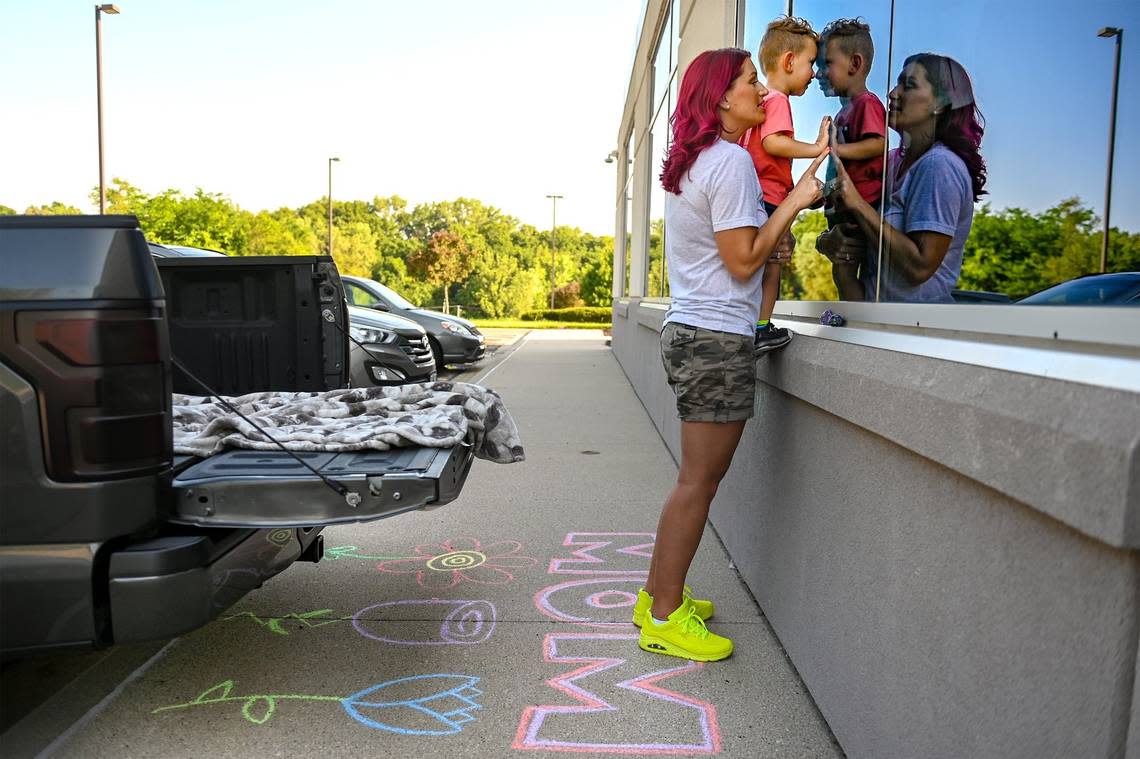 Outside of Kindred Hospital Northland in the summer of 2021, April Shaver of Kansas City held her 2-year-old son, Malakai, up to the window during a visit to see her mother, Gwen Starkey.