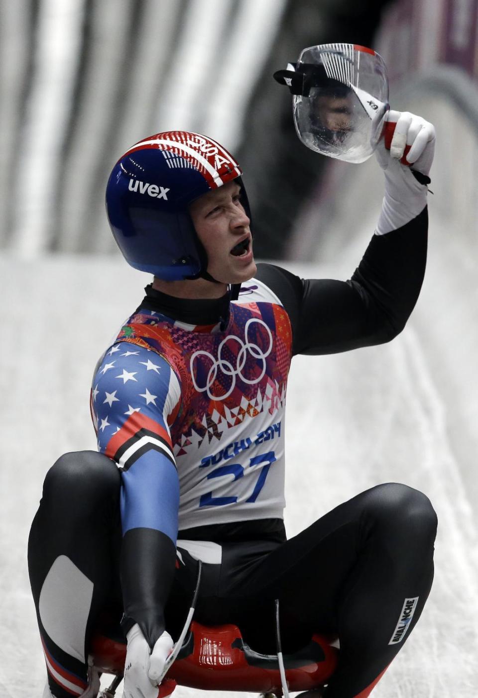 Aidan Kelly of the United States brakes in the finish area after his second run during the men's singles luge competition at the 2014 Winter Olympics, Saturday, Feb. 8, 2014, in Krasnaya Polyana, Russia. (AP Photo/Dita Alangkara)